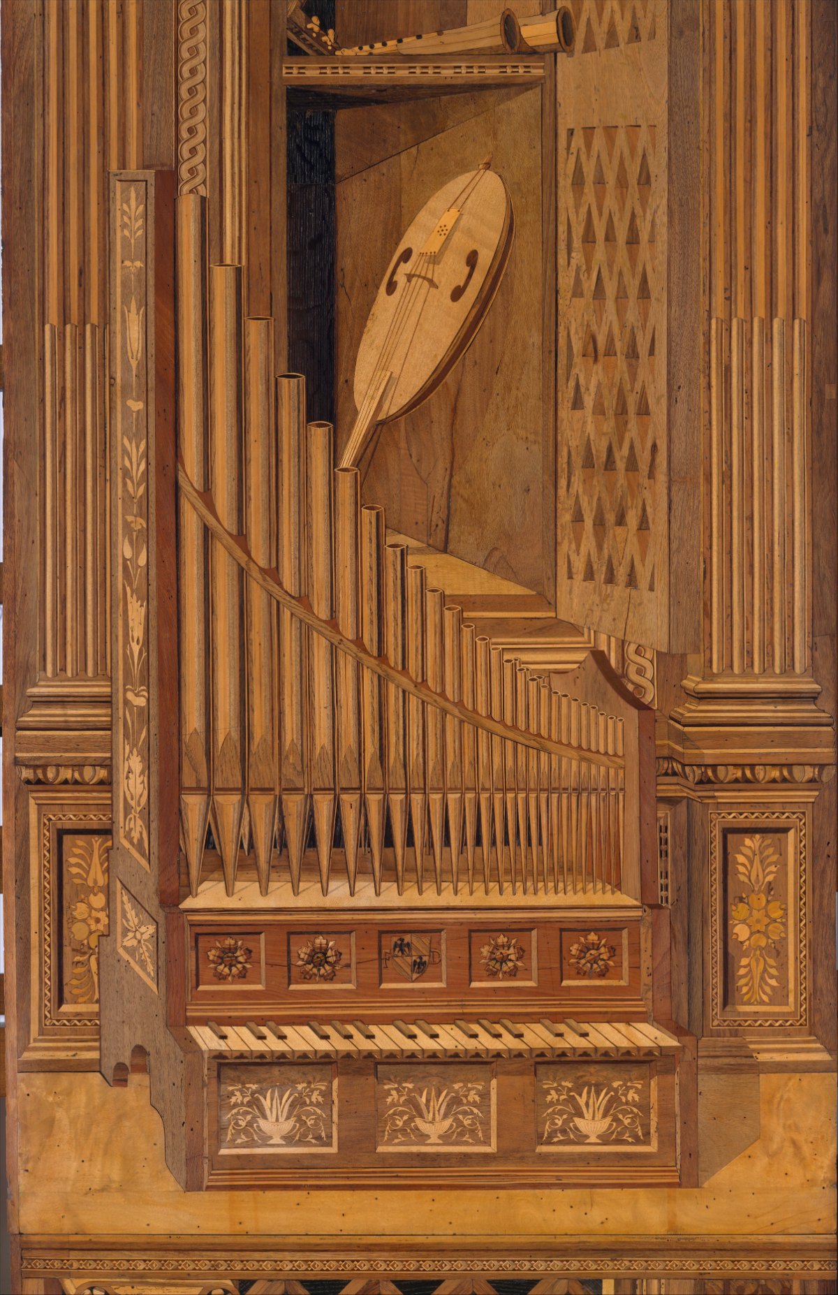 A tall wood-inlay panel depicting, in perspective, a pipe organ with its keyboard, and above it a latticed cupboard door standing open with a lute leaning inside. Everything is rendered flat in thousands of pieces of differently shaded wood.